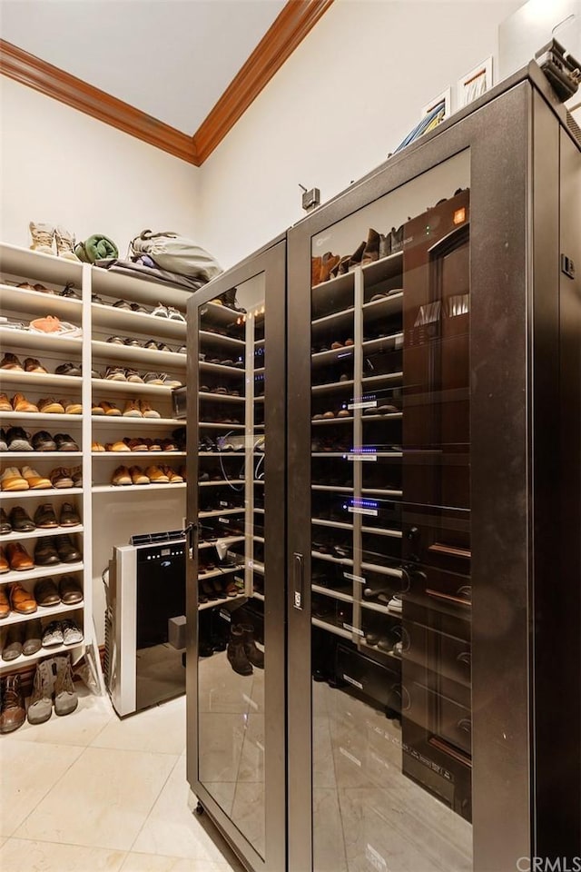 wine cellar with light tile flooring and ornamental molding