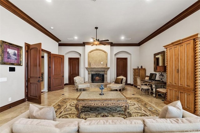 tiled living room featuring a large fireplace, ornamental molding, and ceiling fan