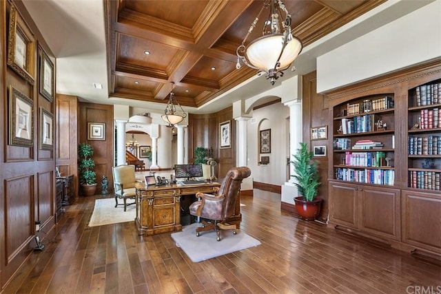 home office with coffered ceiling, ornamental molding, decorative columns, and dark hardwood / wood-style flooring