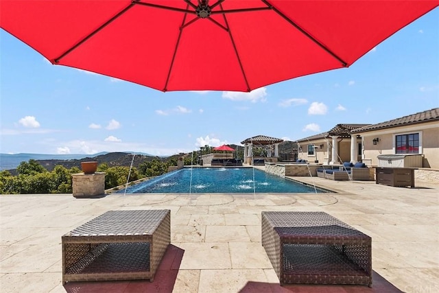 view of pool with a gazebo, pool water feature, and a patio