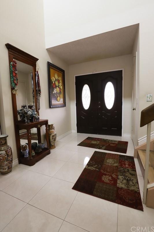 entrance foyer featuring light tile floors