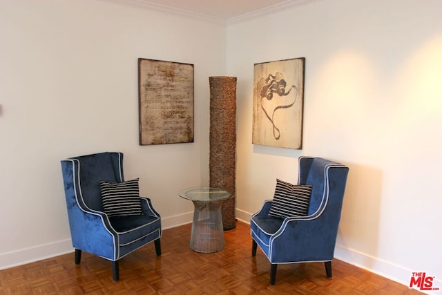 sitting room with crown molding and parquet floors