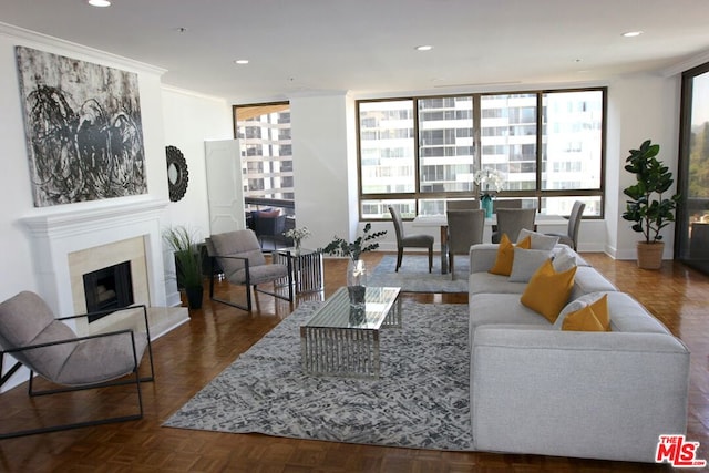 living room featuring plenty of natural light, dark parquet flooring, and crown molding