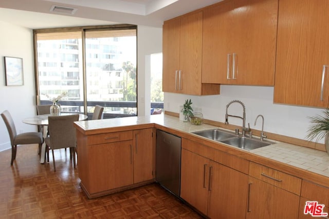 kitchen with a healthy amount of sunlight, dishwasher, and kitchen peninsula