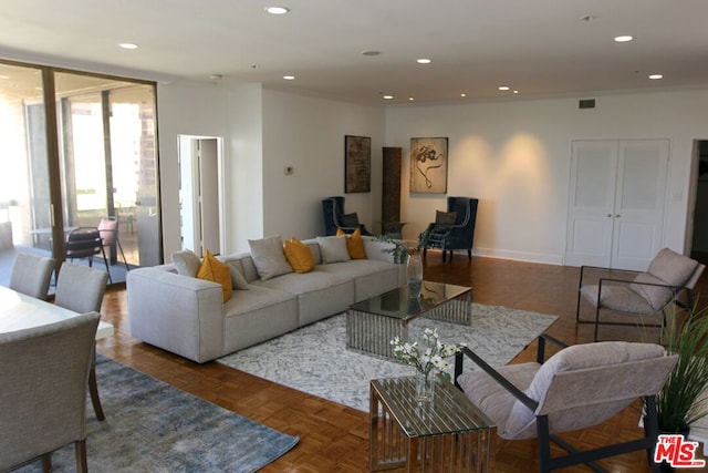 living room featuring dark parquet flooring