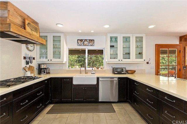 kitchen with sink, white cabinets, light tile patterned floors, and appliances with stainless steel finishes