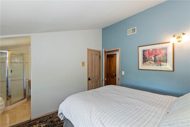 bedroom with light tile patterned floors and vaulted ceiling