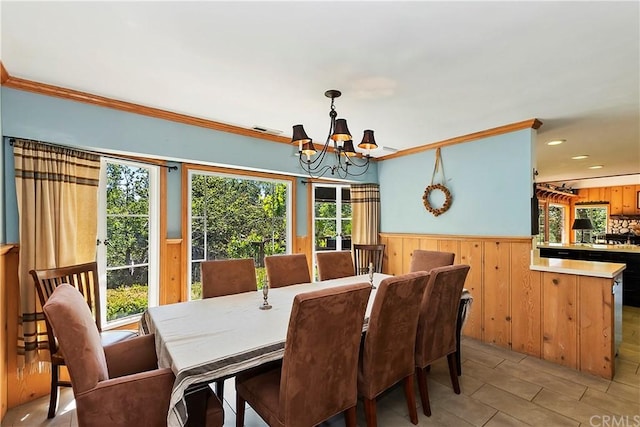 dining room featuring a notable chandelier and crown molding