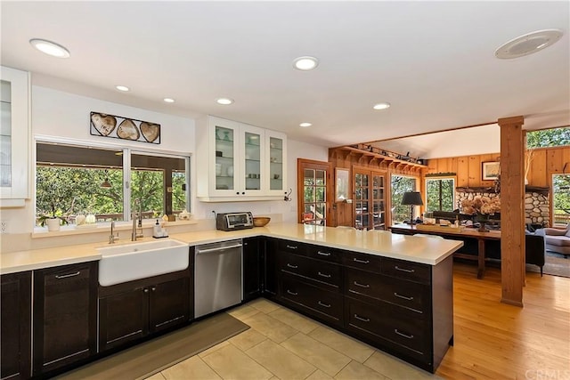 kitchen featuring stainless steel dishwasher, sink, a wealth of natural light, and kitchen peninsula