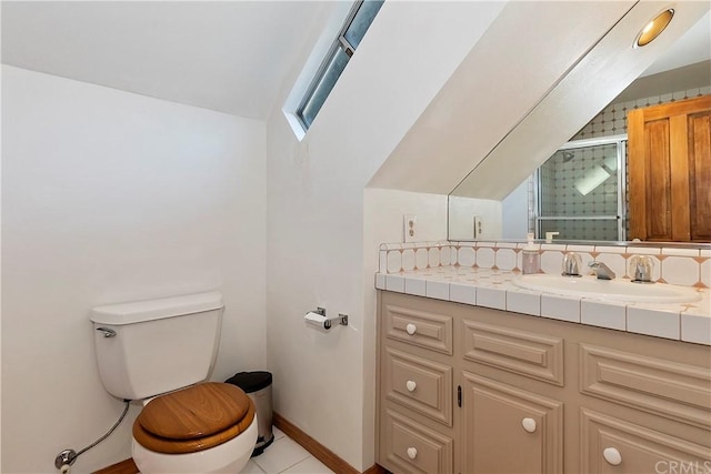 bathroom featuring toilet, vaulted ceiling, a shower with door, tile patterned floors, and vanity