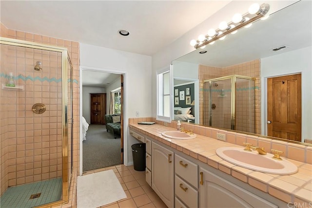 bathroom featuring walk in shower, vanity, and tile patterned floors