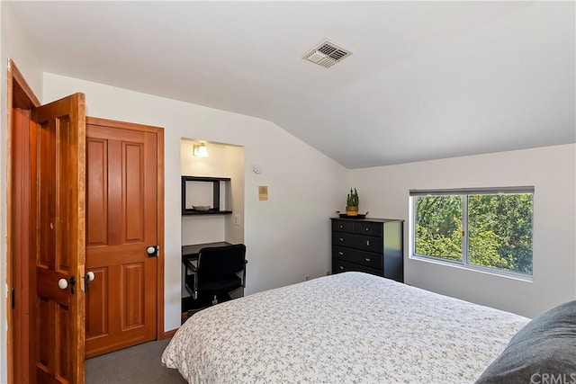 bedroom featuring vaulted ceiling and carpet floors