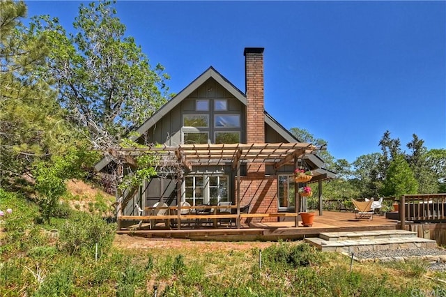 back of house featuring a pergola and a wooden deck