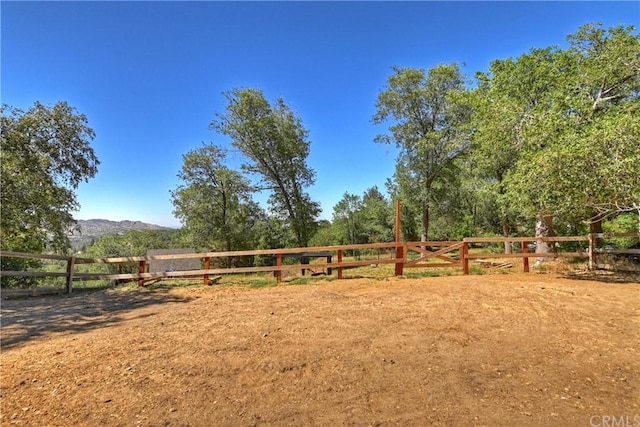 view of yard featuring a rural view and a mountain view