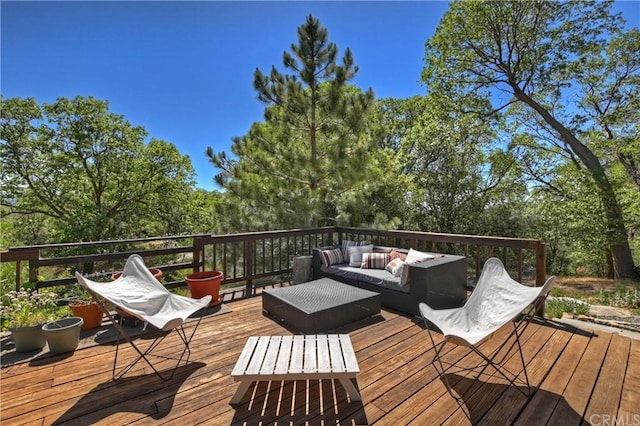 wooden terrace featuring an outdoor hangout area