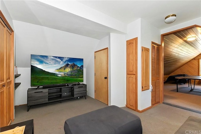 living room featuring wood walls and light carpet