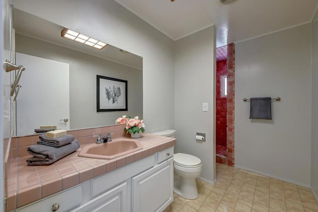 bathroom with vanity, toilet, and tile patterned flooring