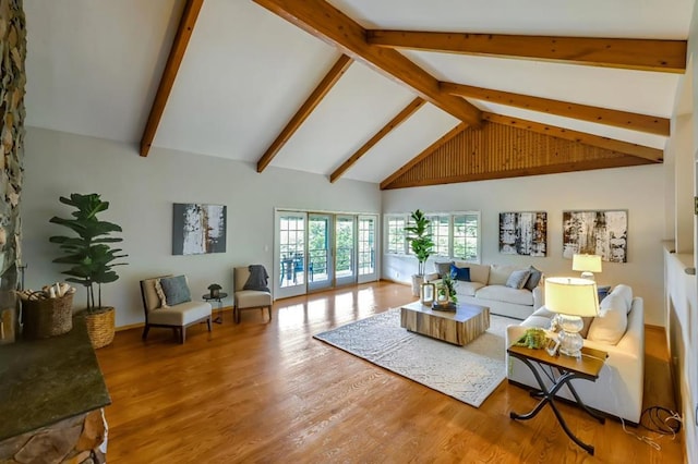 living room with high vaulted ceiling, hardwood / wood-style floors, and beamed ceiling