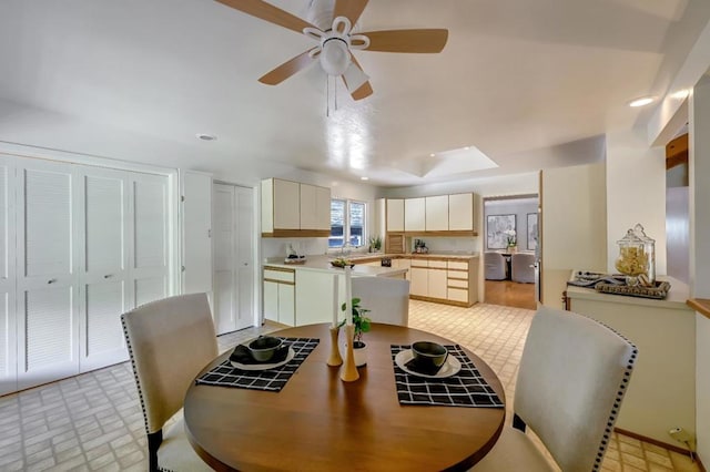 dining space with ceiling fan and light tile patterned floors