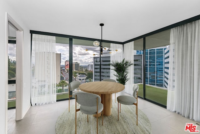 tiled dining area with a wealth of natural light, a chandelier, and expansive windows