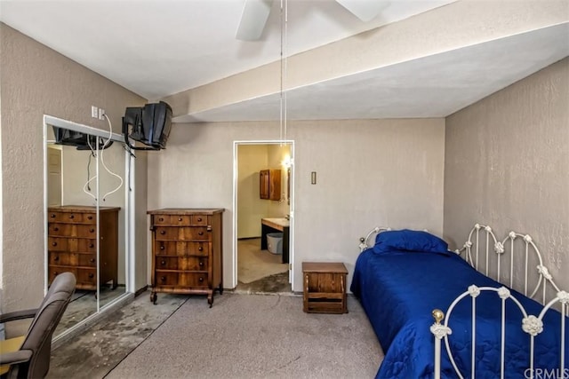 bedroom with ensuite bath and ceiling fan