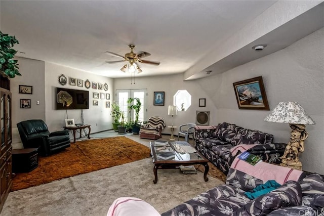 living room with ceiling fan and light colored carpet