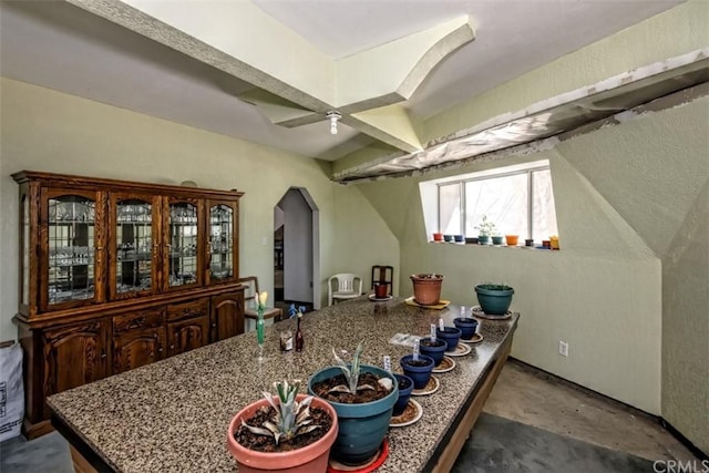 kitchen with concrete floors and stone countertops