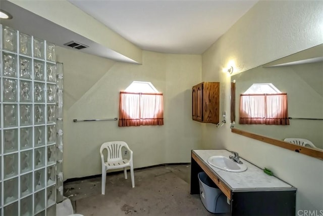 bathroom featuring concrete flooring, a wealth of natural light, and vanity