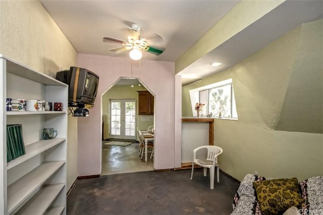 interior space with ceiling fan and french doors