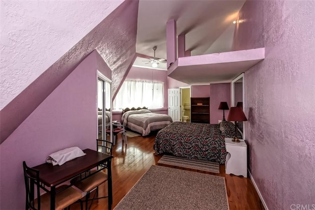 bedroom with a textured ceiling, ceiling fan, and dark wood-type flooring