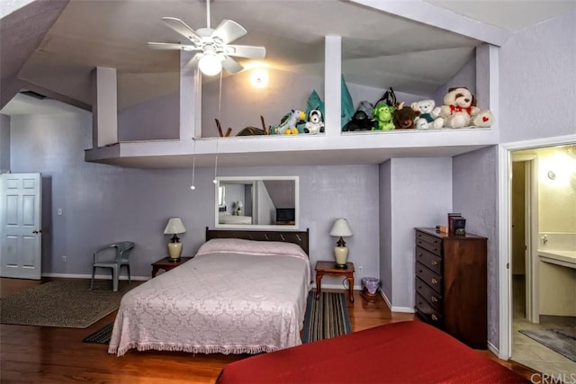 bedroom featuring lofted ceiling, dark tile flooring, and ceiling fan