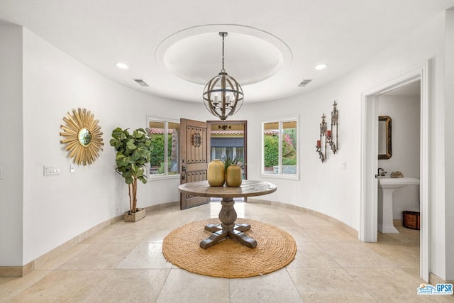 interior space with light tile patterned floors and a notable chandelier