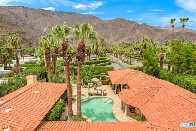 view of swimming pool featuring a mountain view and a patio