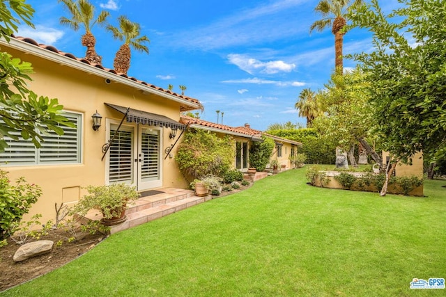 view of yard featuring french doors