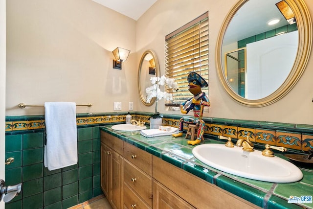 bathroom featuring vanity and tile walls