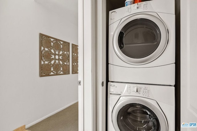 clothes washing area with carpet floors and stacked washing maching and dryer