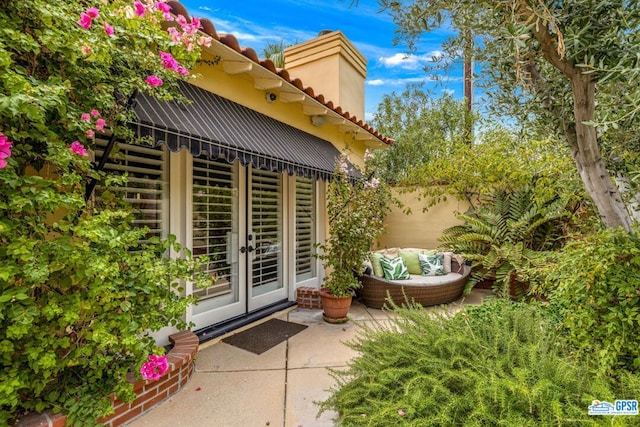 entrance to property featuring a patio and french doors