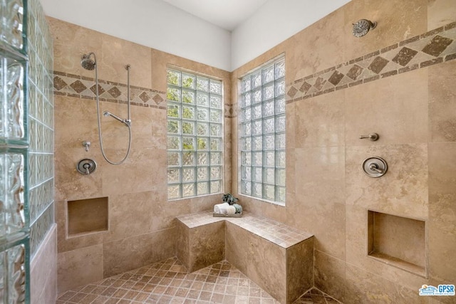 bathroom with tiled shower