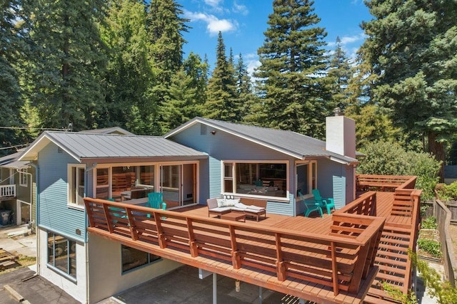 rear view of property with a wooden deck