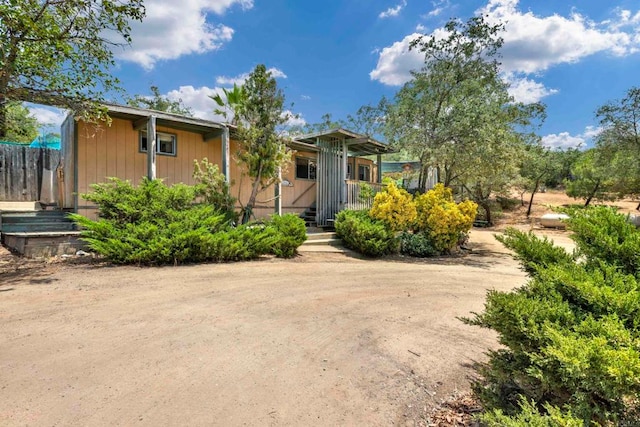 view of front of home featuring fence