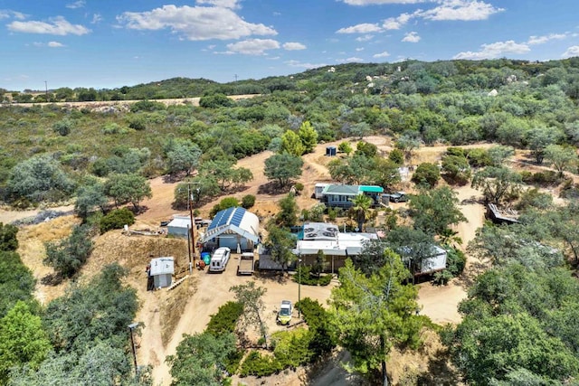 bird's eye view featuring a wooded view