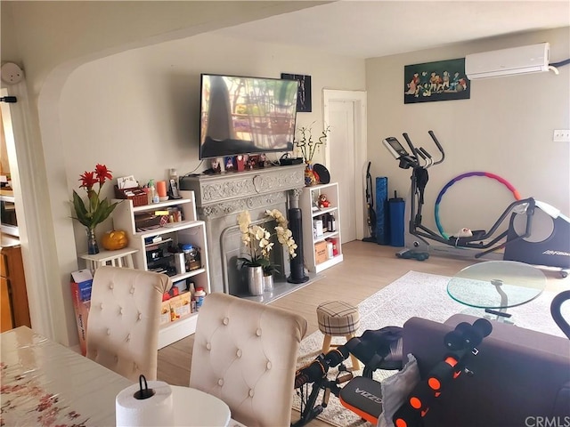 game room with wood-type flooring and a wall unit AC