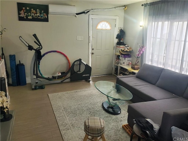 living room with hardwood / wood-style flooring and a wall unit AC