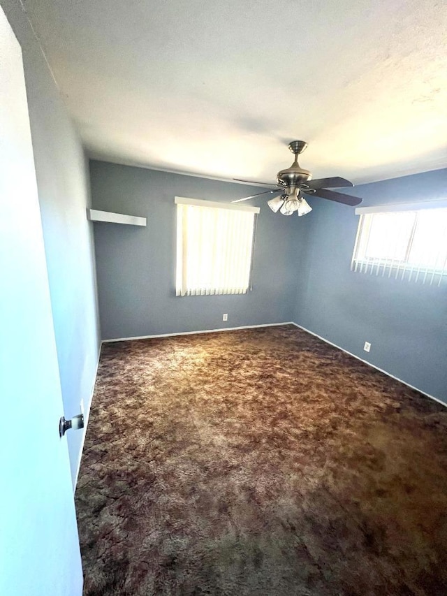 carpeted empty room featuring ceiling fan