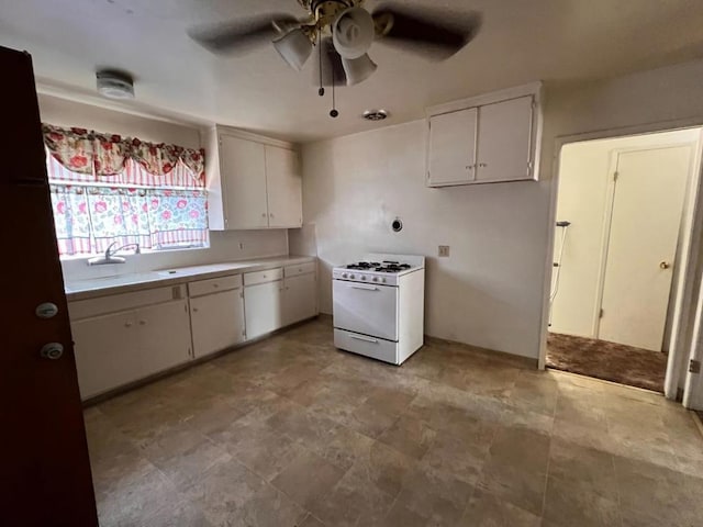 kitchen featuring ceiling fan, white cabinets, light tile patterned floors, and white range with gas stovetop