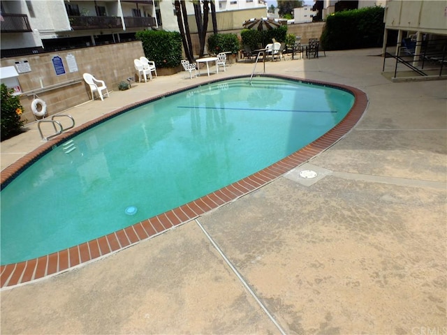 view of swimming pool featuring a patio area