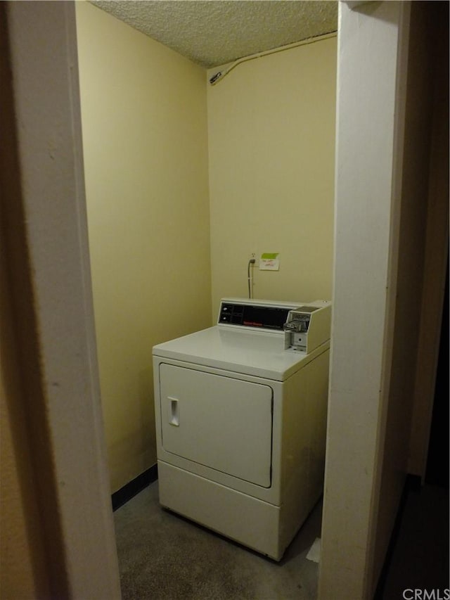 washroom with washer / clothes dryer and a textured ceiling