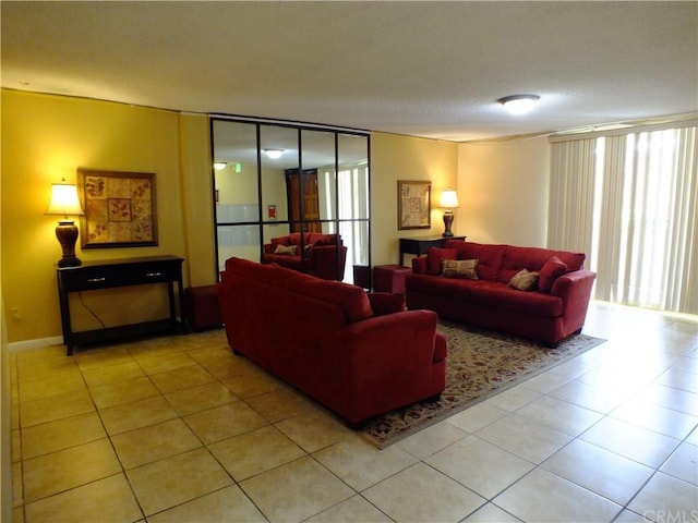 living room featuring a healthy amount of sunlight and light tile floors