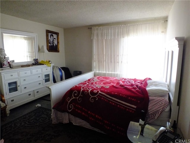 carpeted bedroom featuring a textured ceiling