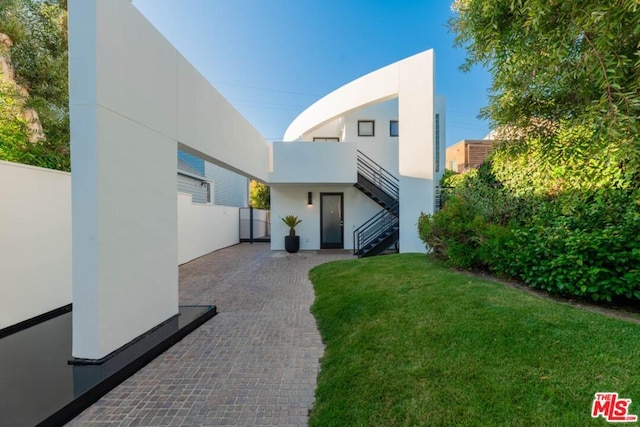 rear view of house featuring a yard